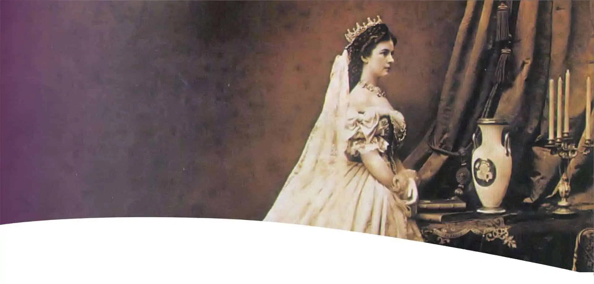A woman in an elegant historical dress and crown stands at a table with a vase, books and a candelabra, gazing thoughtfully to the right against a sepia-colored background.